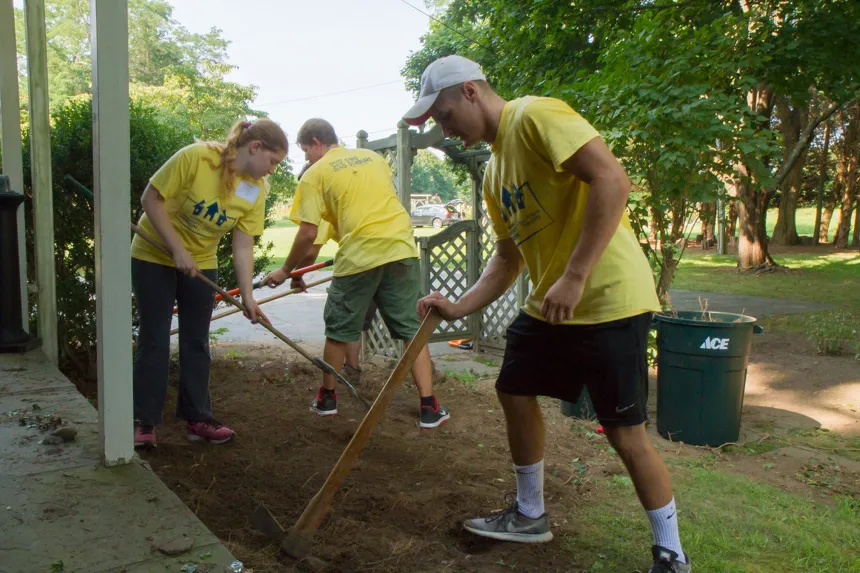 Students working digging whole.