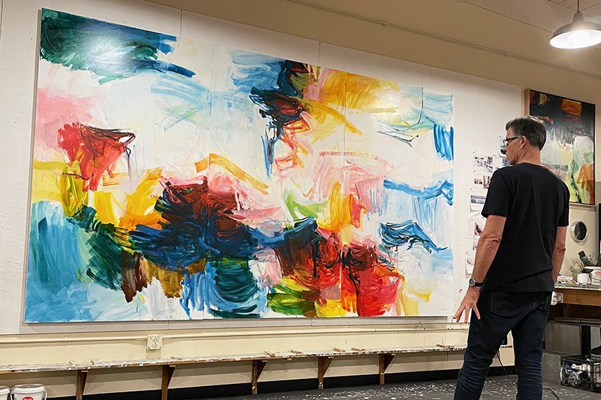Michael Rich observing his abstract painting, "La Serenata."