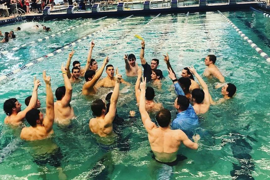 men's swim team celebrates in pool