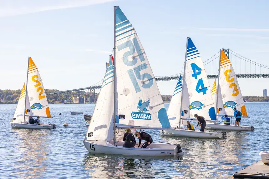 Sailboats depart from the Bristol campus to the Mount Hope Bay.