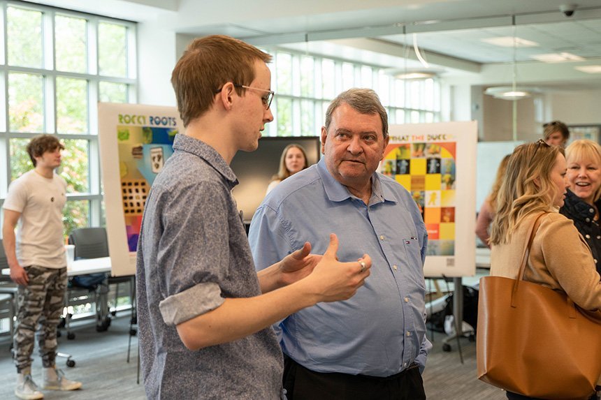 A student speaking with President Miaoulis at SASH.