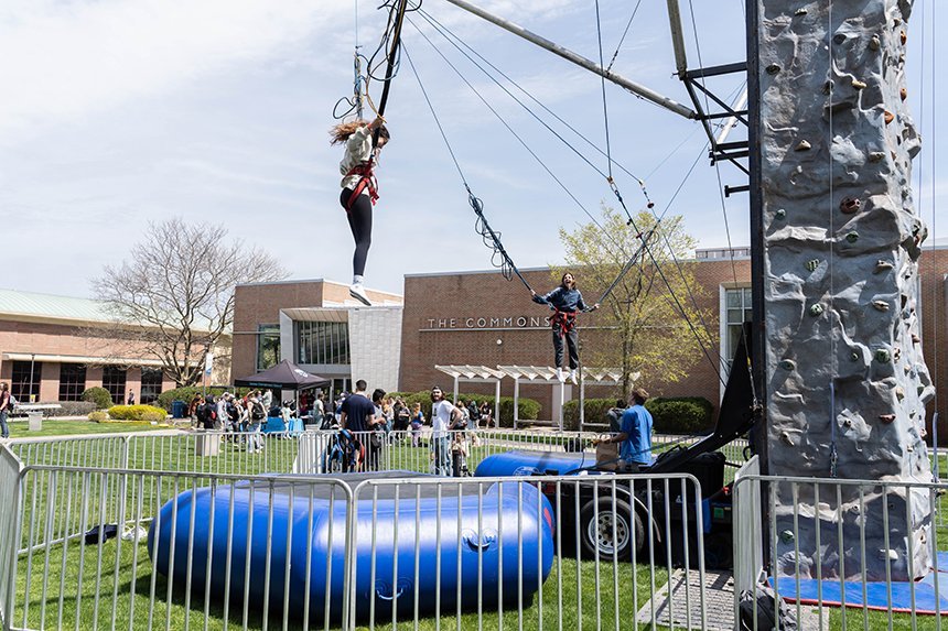 Two students bounce on the bungee trampolines. 
