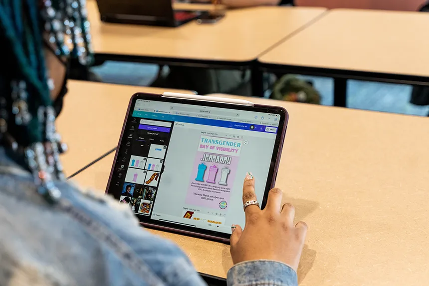 Madison Dixon designs a flyer for Trans Day of Visibility on her iPad. 