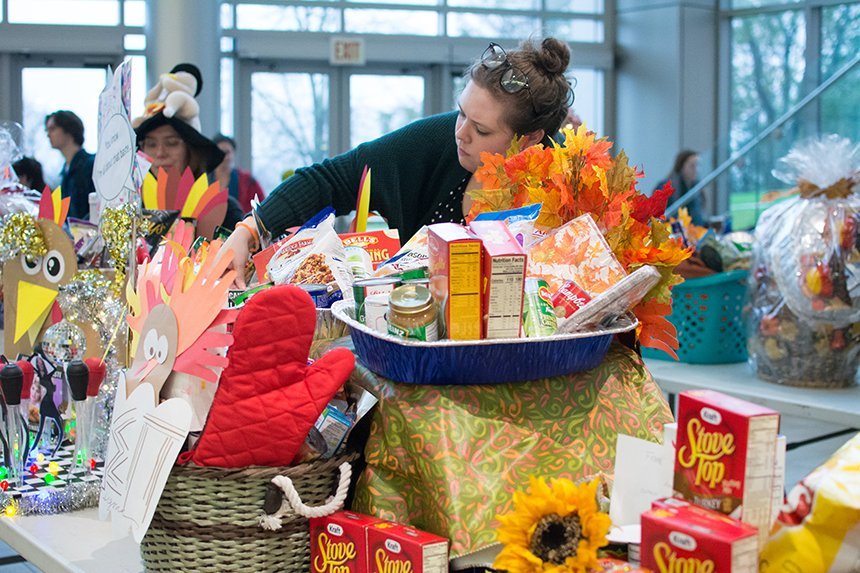 Turkey baskets lined on a table, filled with donated food.