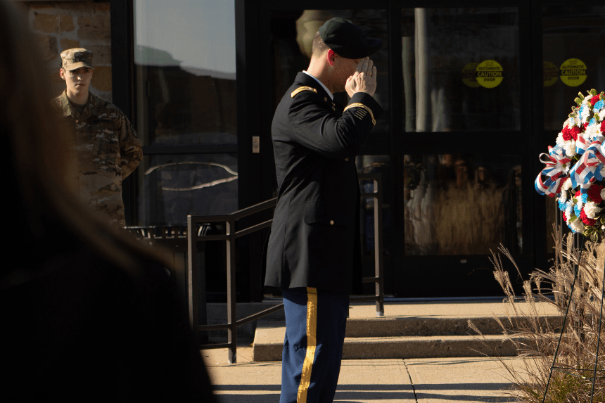 Soldier salutes the flag.