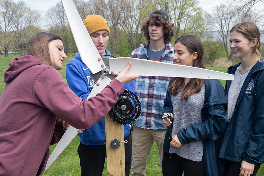 Engineering students working on the blades of their wind turbine 