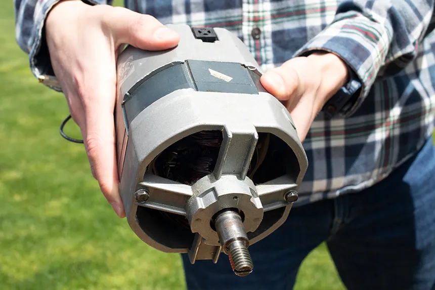 An Engineering student holding a motor 