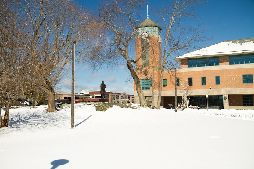 The RWU campus and Roger statue in the winter.