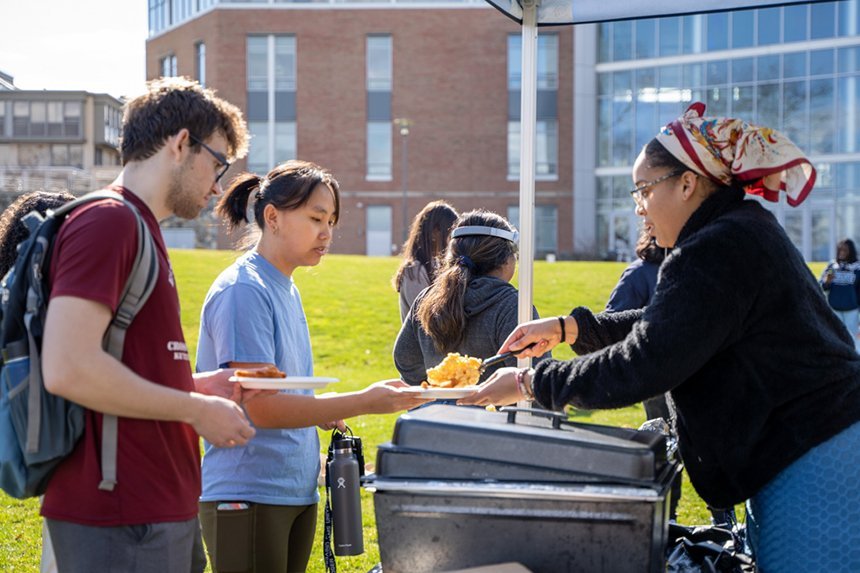 A student serves another student a plate of mac and cheese during MSU's Field Day.