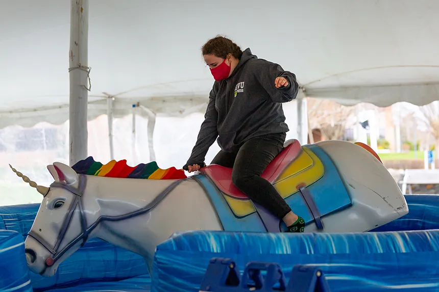 Student rides mechanical unicorn