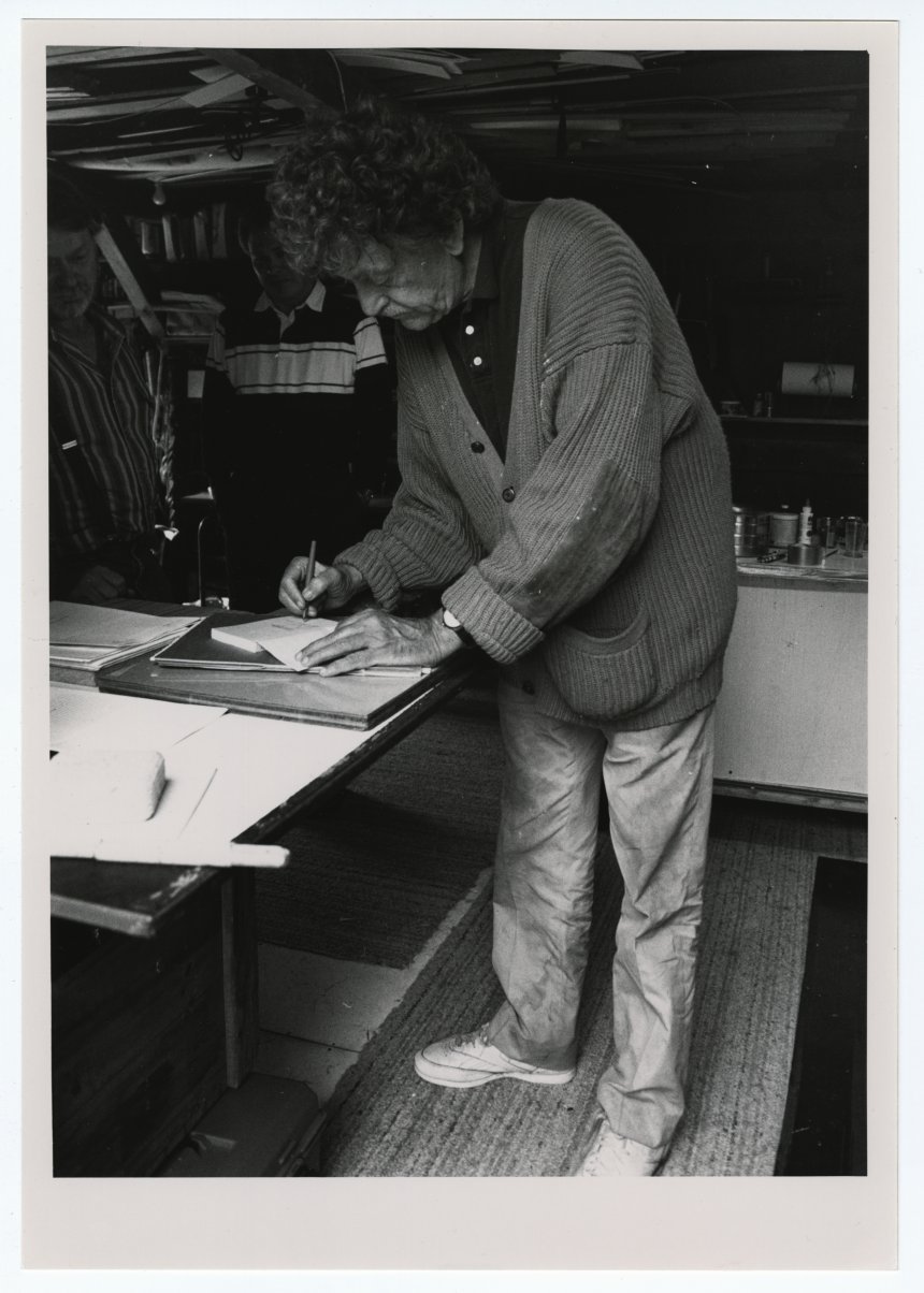 Photograph of Vonnegut signing a book in Sag Harbor, Maine in 1990.