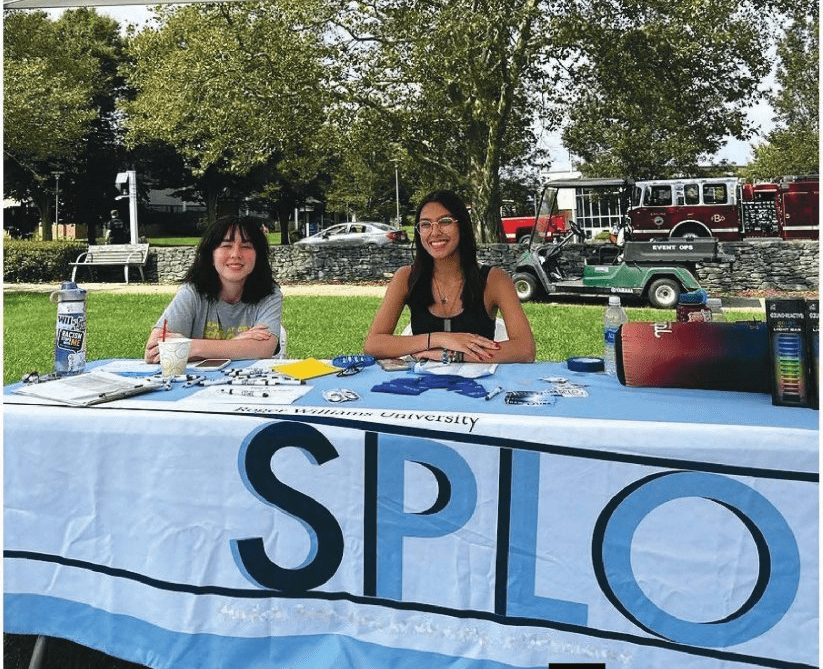 Students sitting at Student Programs Table at Involvement Fair