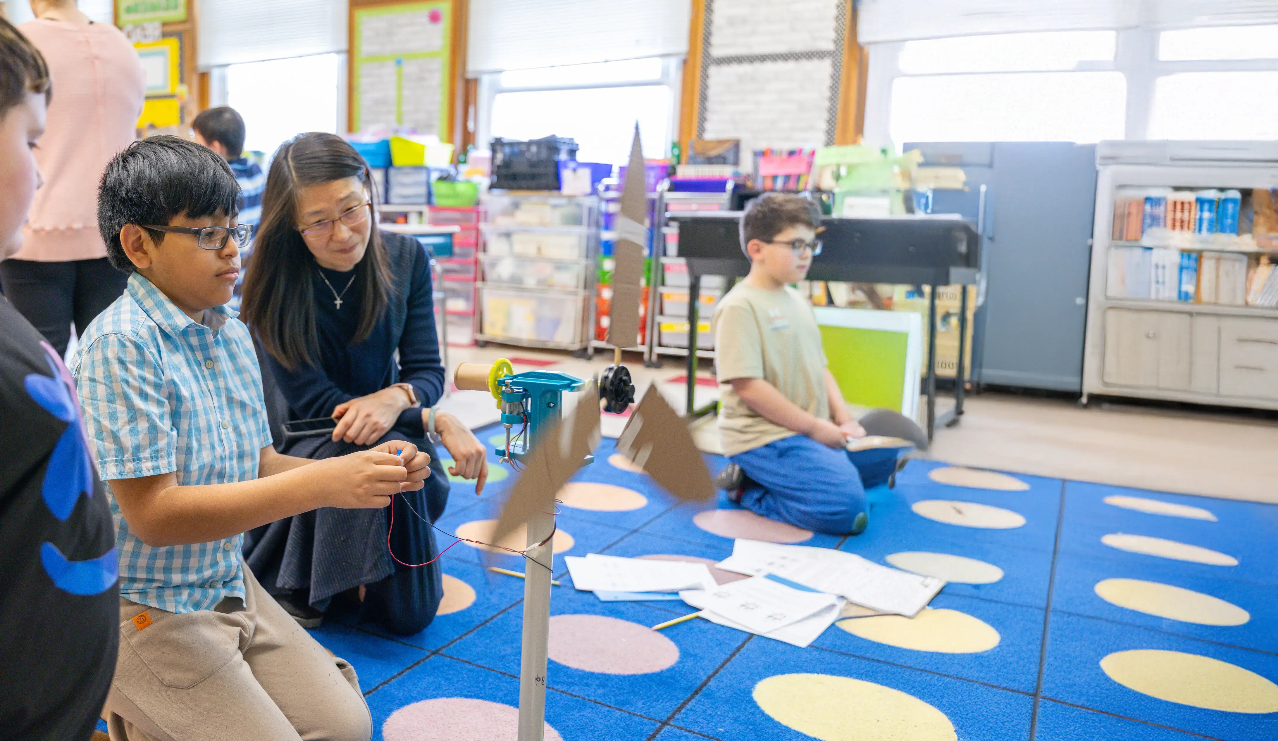 A teacher works with a student