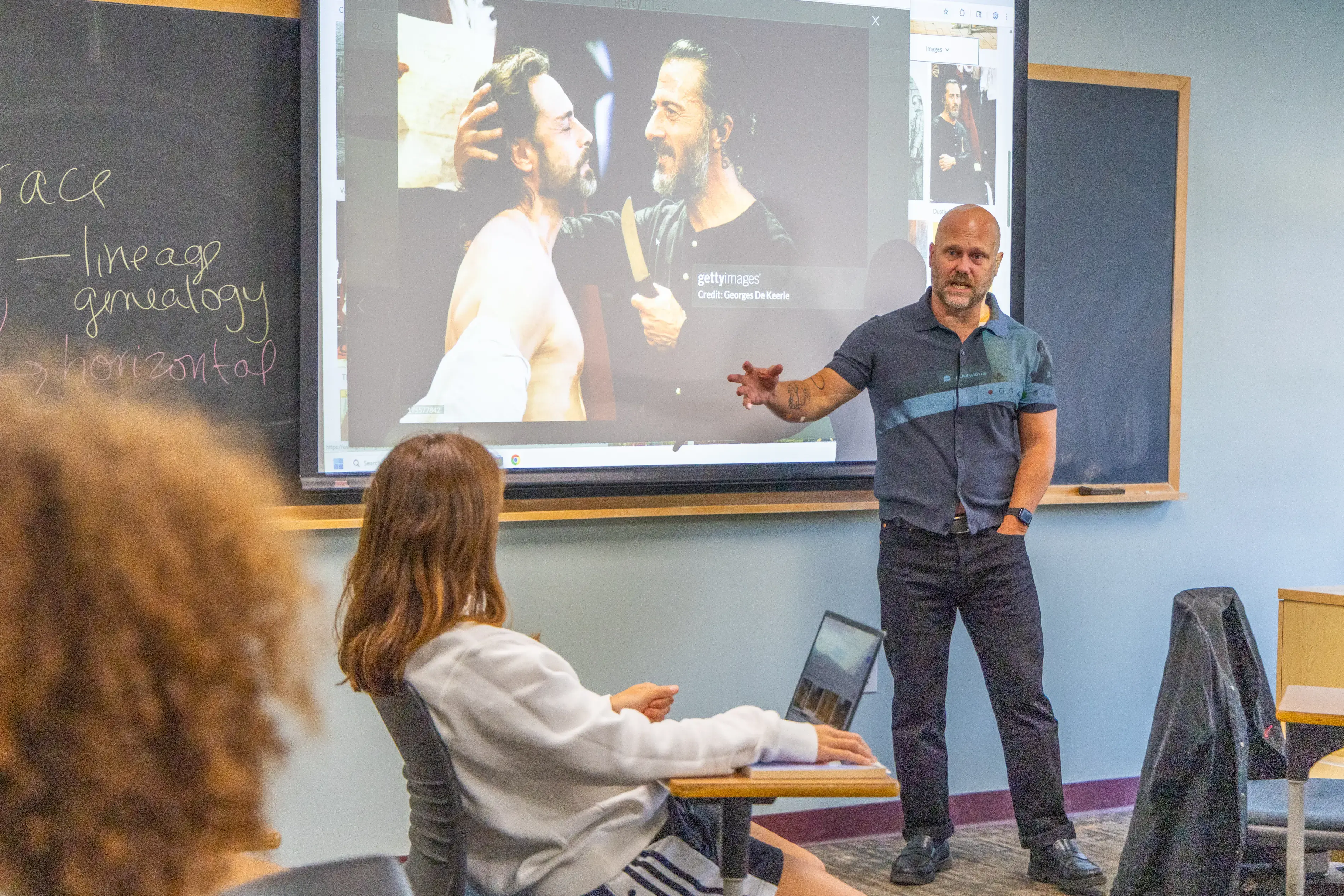 A professer lectures to a room of students