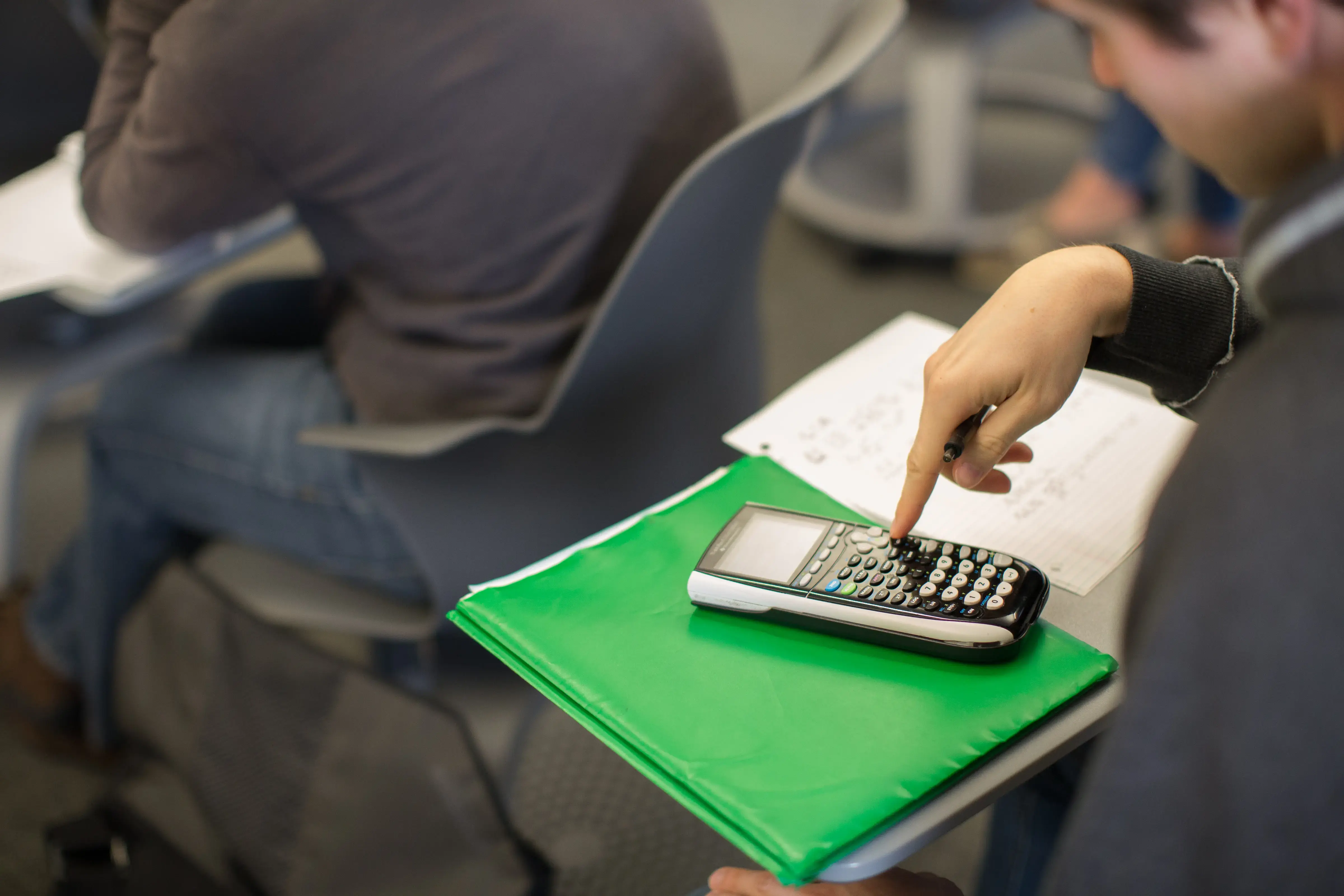 Student with Calculator in class