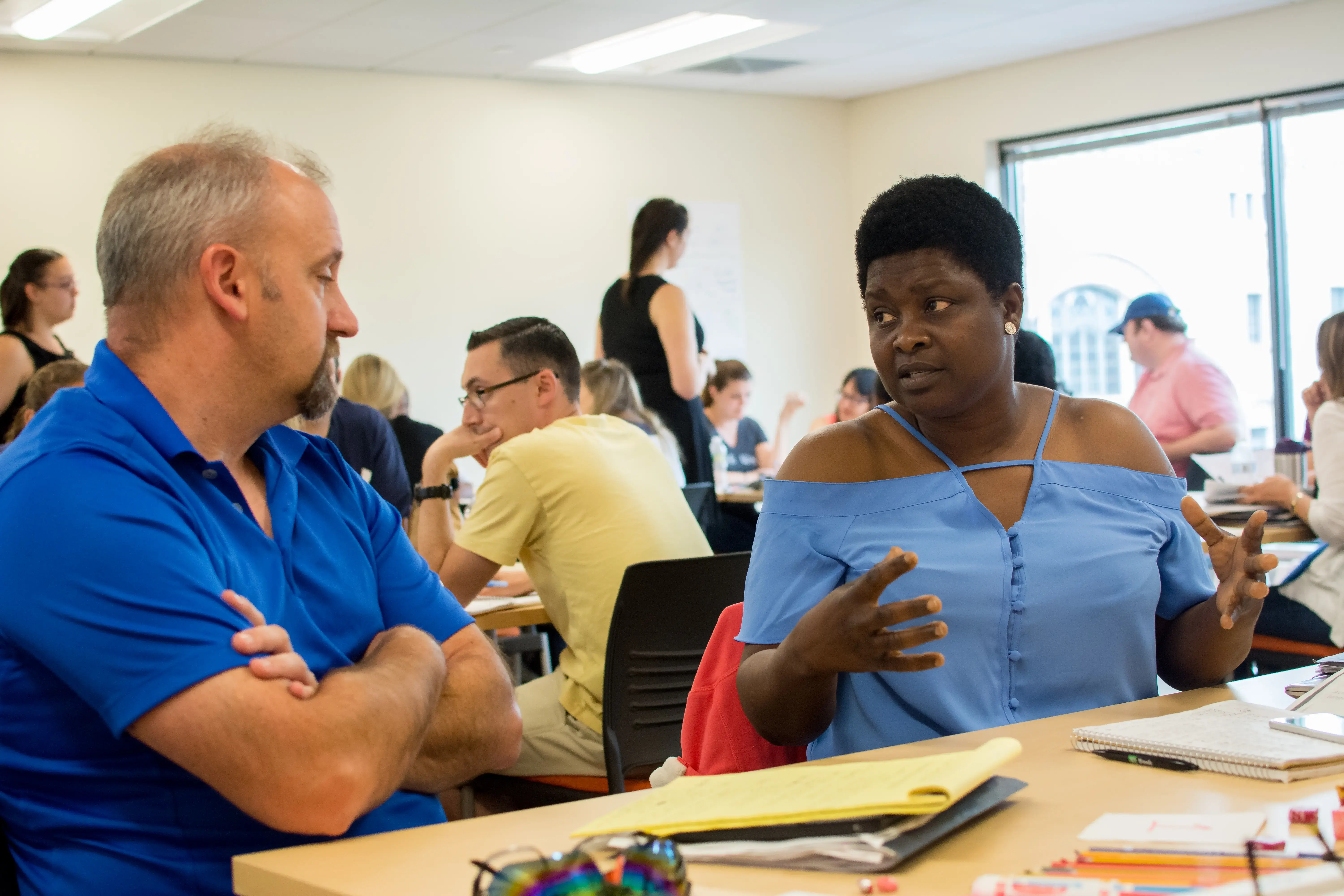 ESL students discuss a project in a classroom