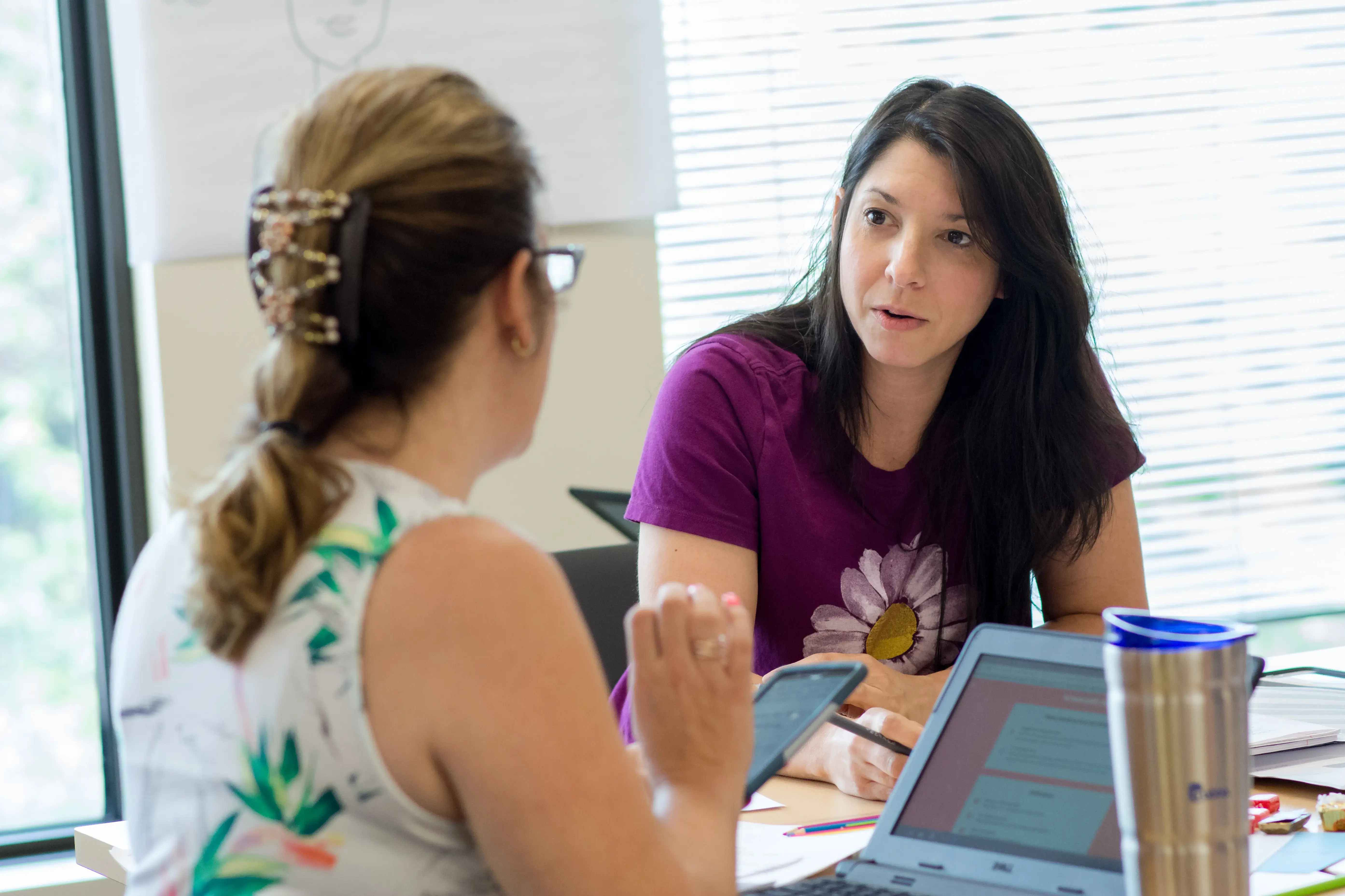 ESL student discuss a project in a classroom