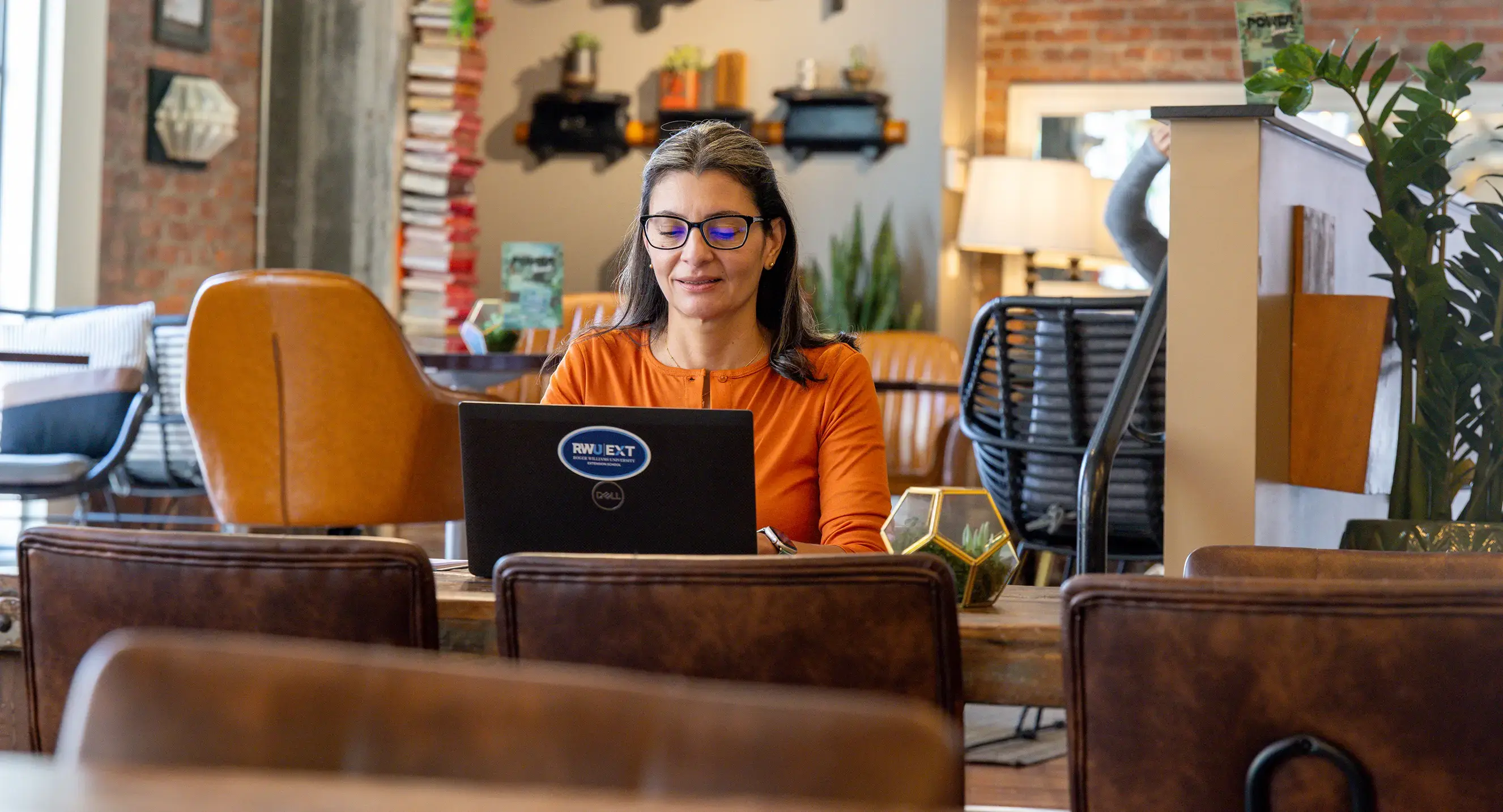 An EXT School student joins a class from a cafe