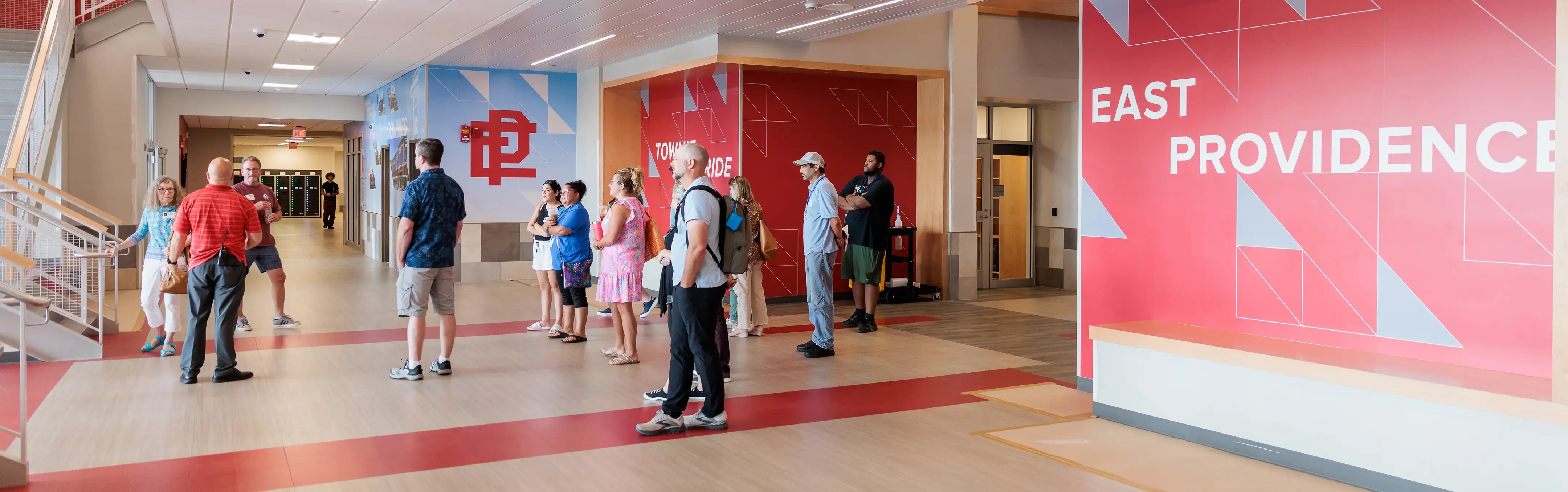 School administrators discuss financial operations inside a high school hallway