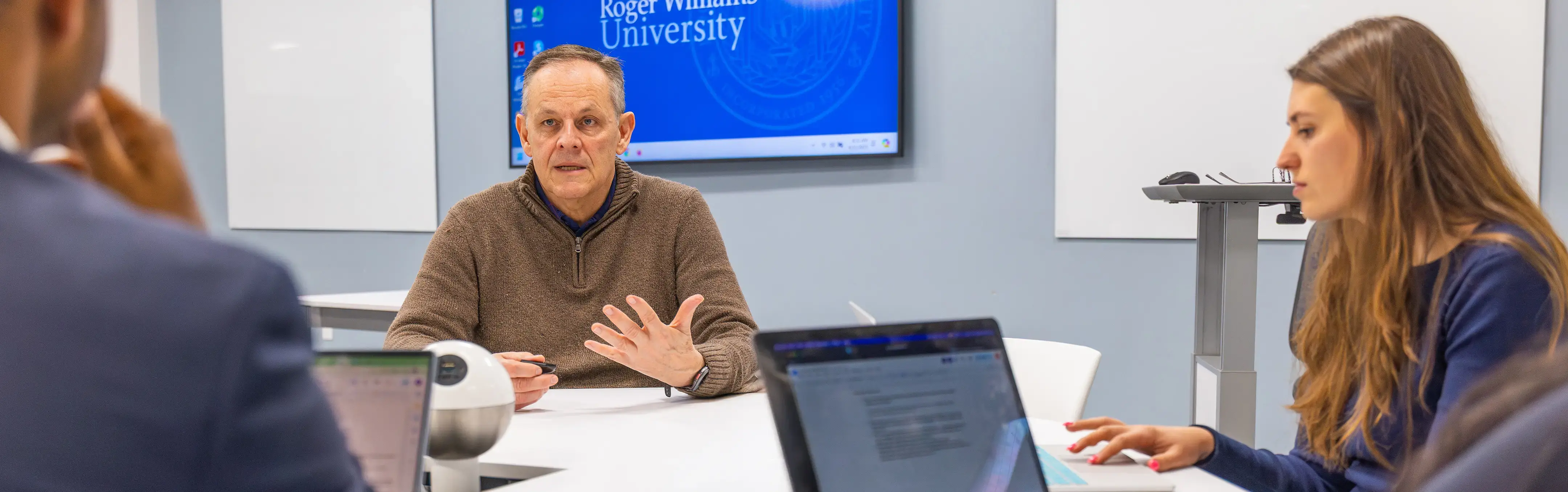 A professor works with students