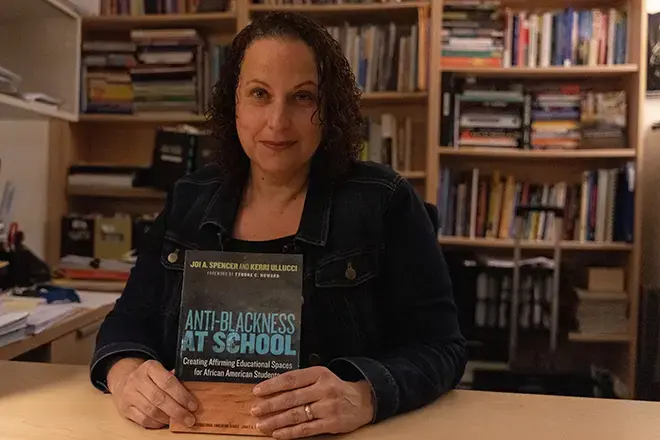 Kerri Ullucci holds her book