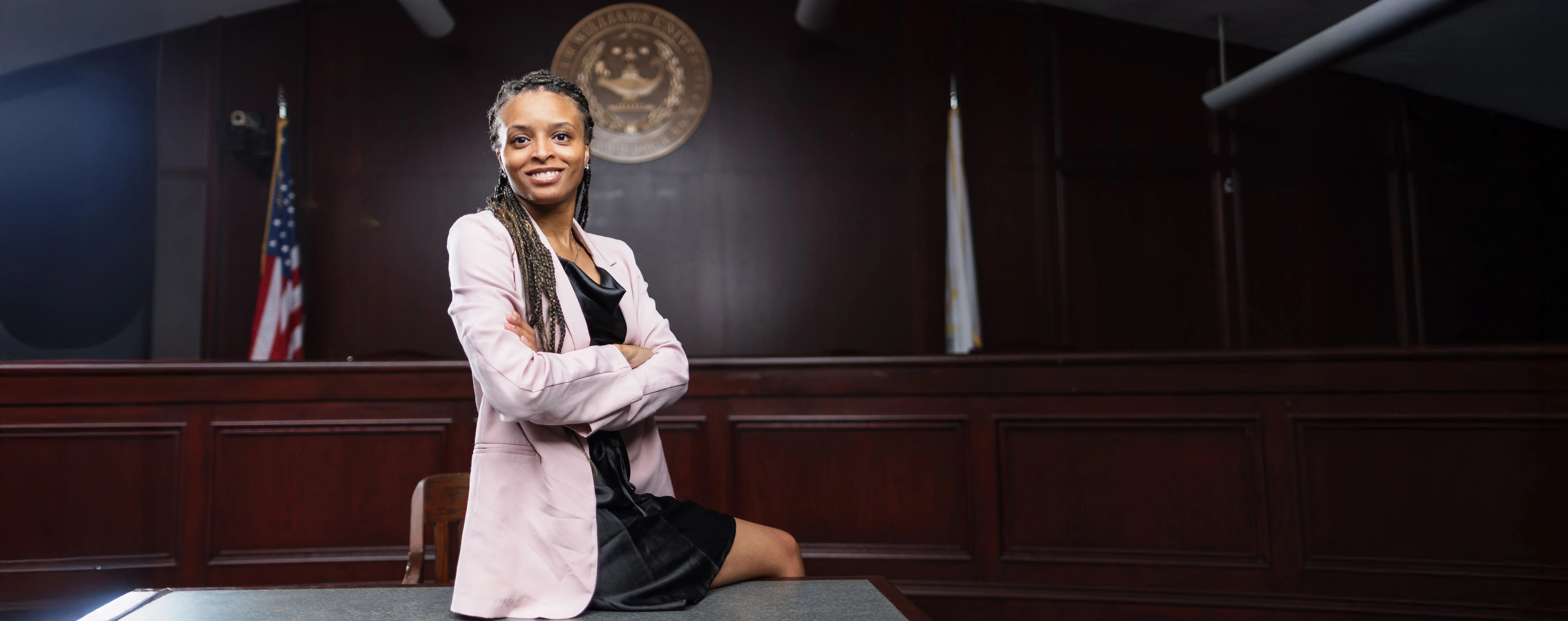 A lawyer sits confidently in the courtroom