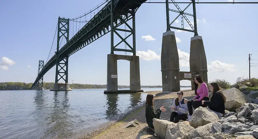 Students chat under Mount Hope Bridge