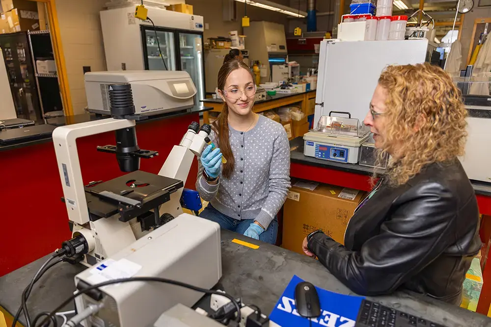 Student works with professor in lab