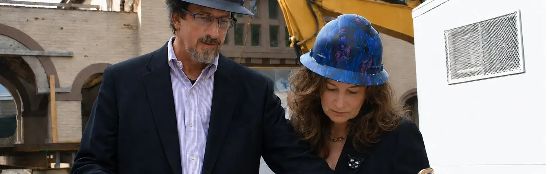 Project managers examining plans at a site