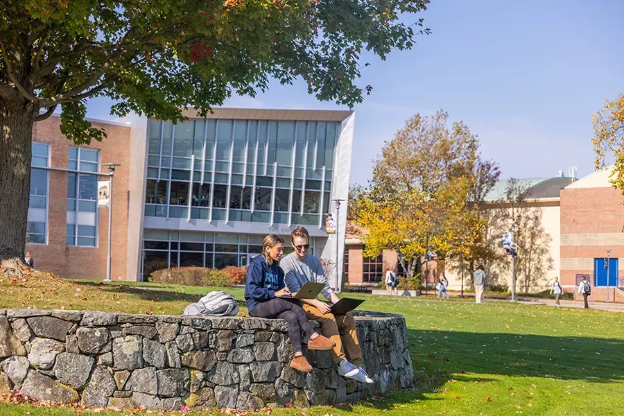 Students working on computers outdoors