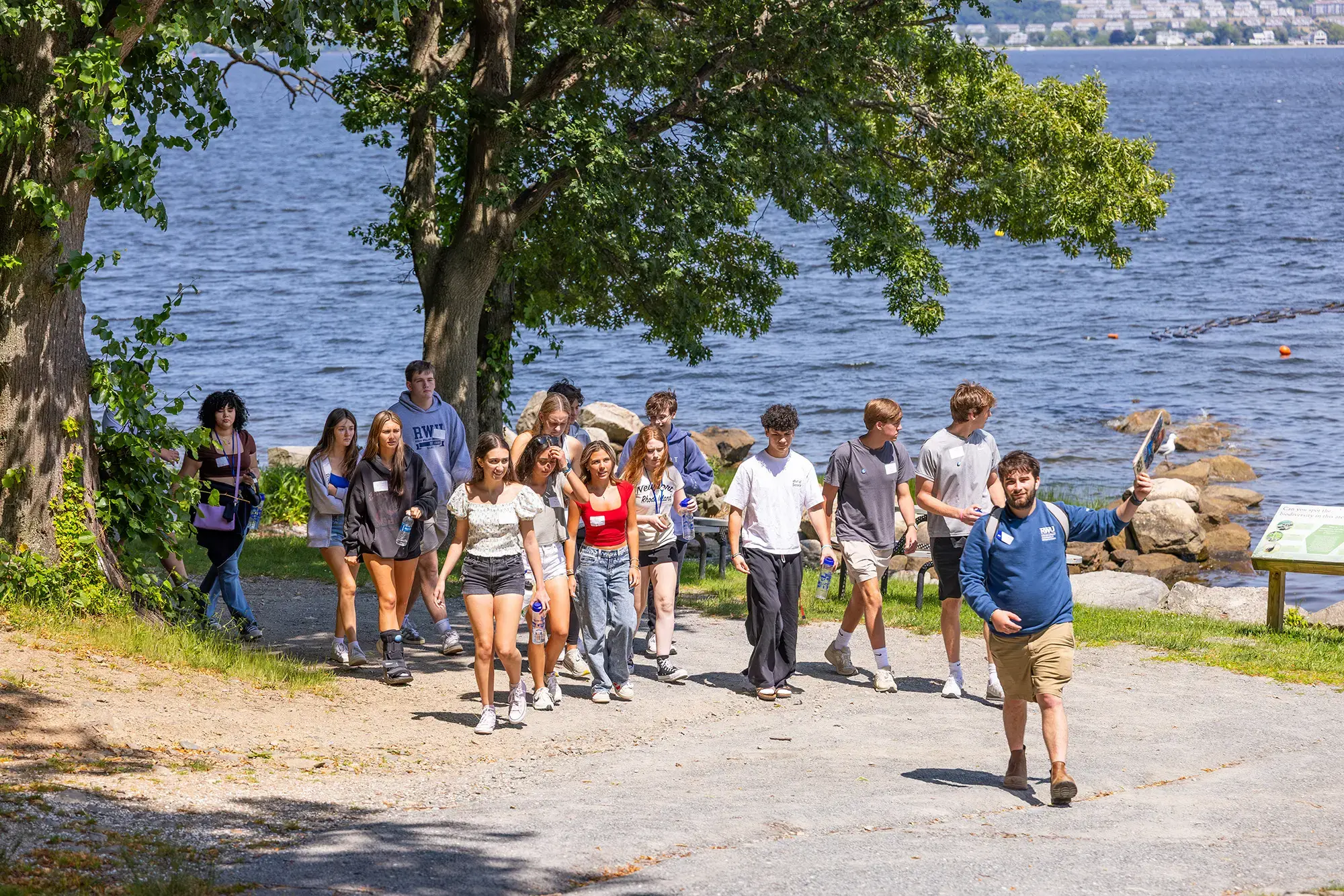 Students walk by bay on tour