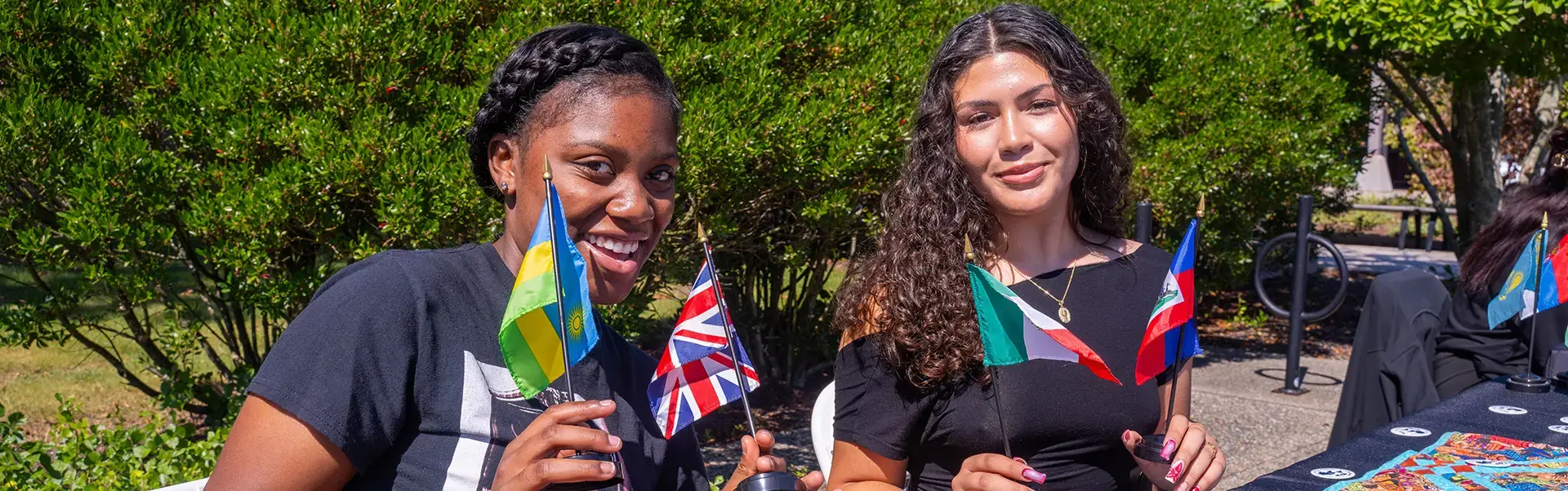 Students hold flags of various countries