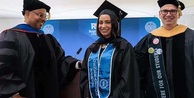 Graduate wears a stole that says "first generation"